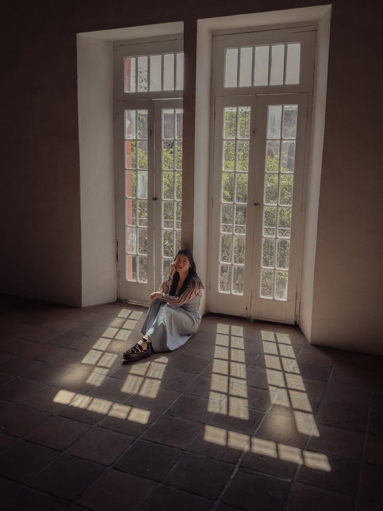 Woman Sitting On Floor Near Door