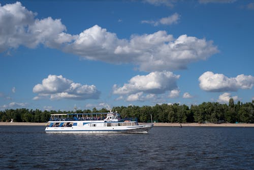 View of a Passenger Ship on a Body of Water near a Shore 