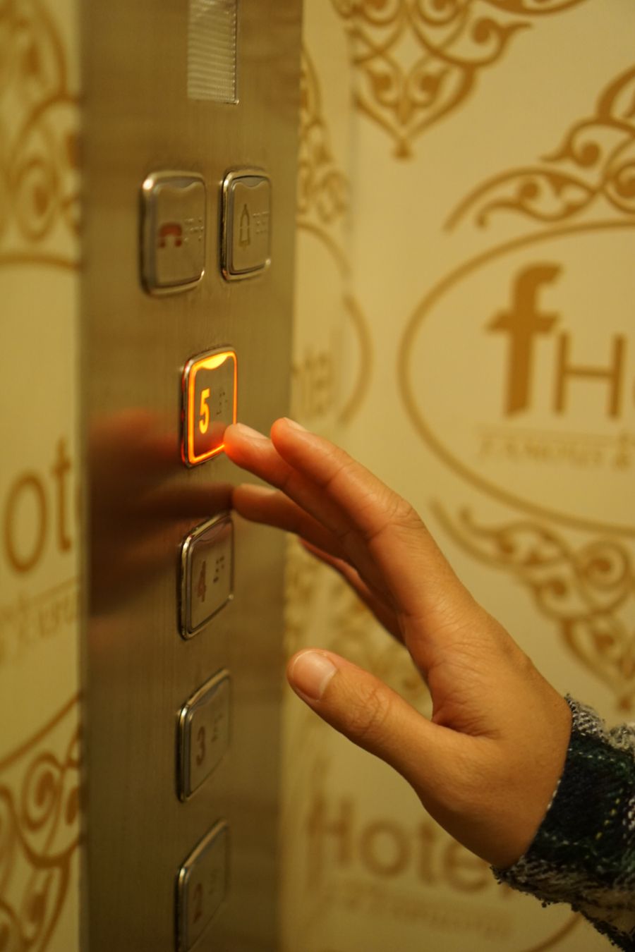 Elevator landing operating panel hall call buttons on architectural wall