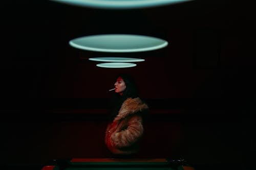 Woman with a Cigarette in Her Mouth Standing by the Billiard Table 