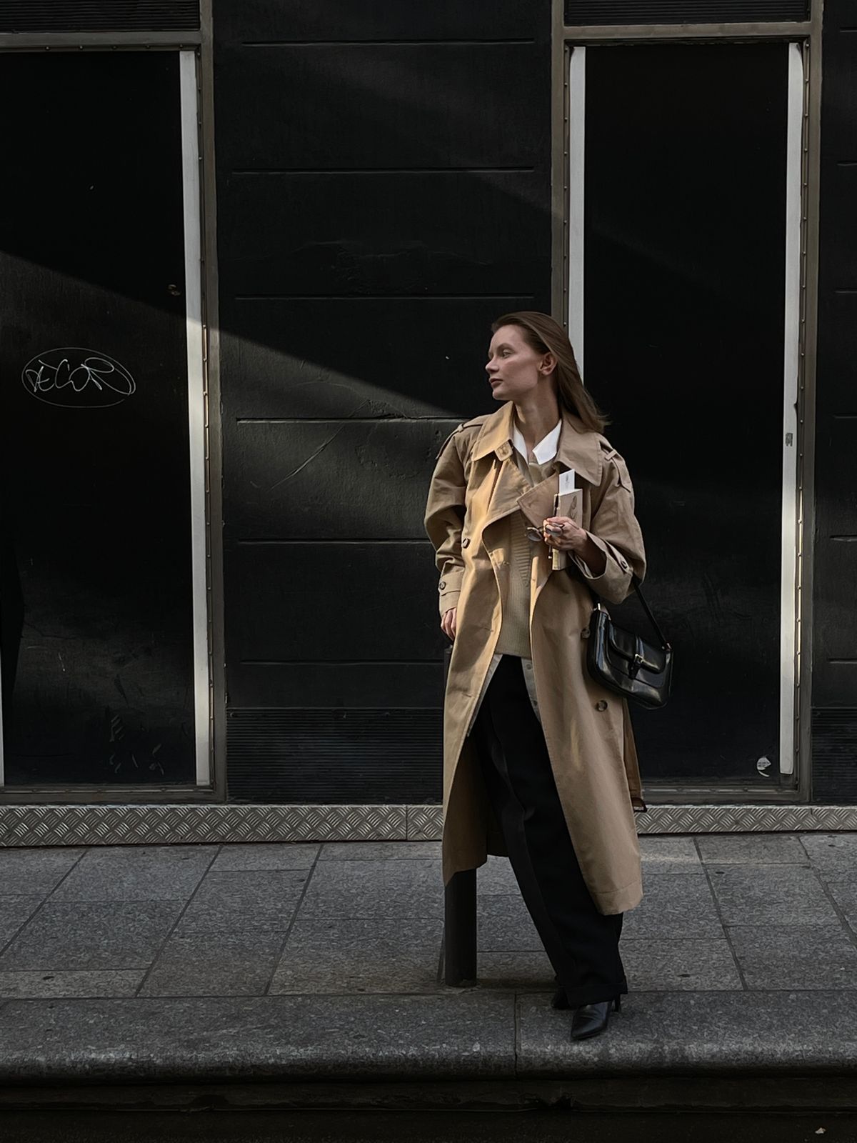 A woman wearing a coat in the city — the modern trench