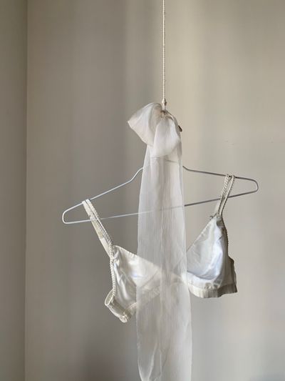Satin slip on a wire hanger by Eugenia Remark on Pexels