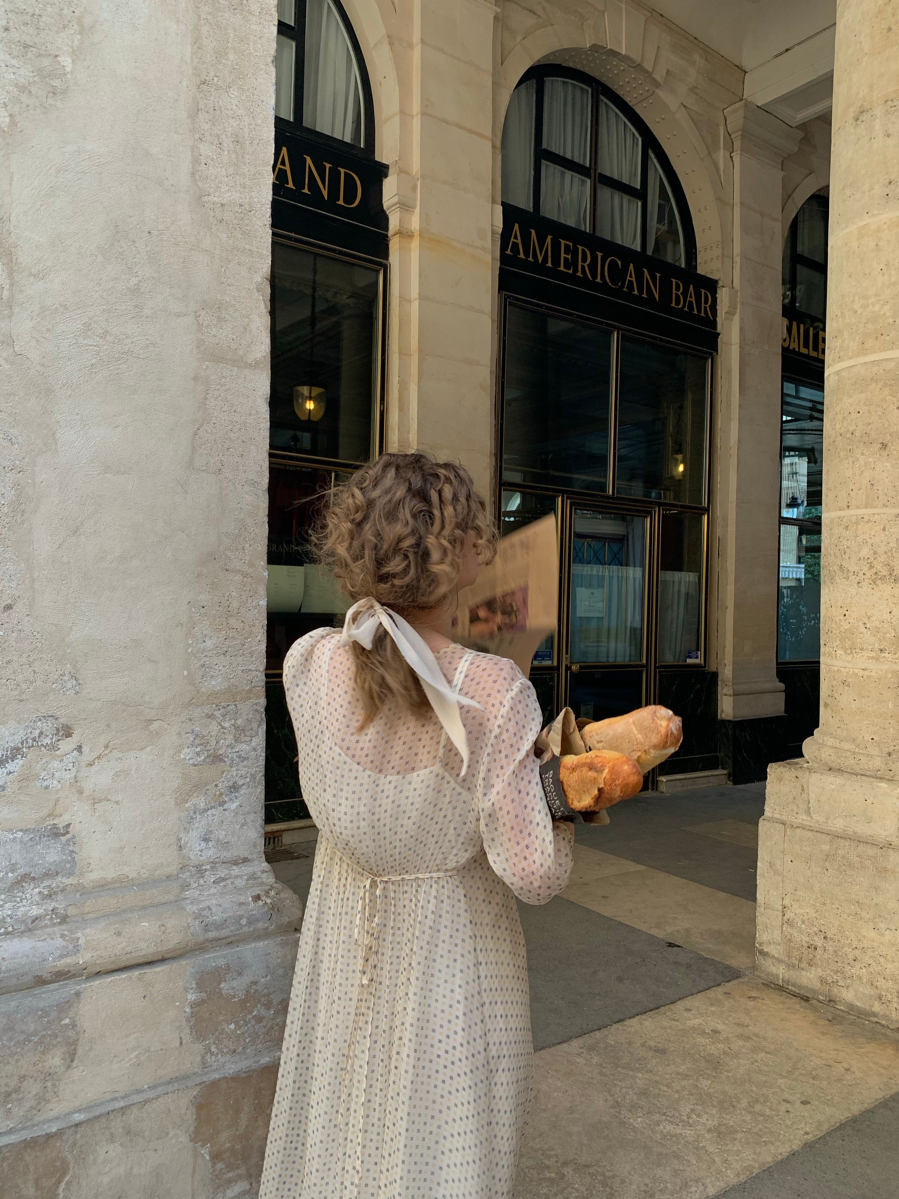 Woman in Old Fashioned Dress Holding Newspaper and Baguettes  Free Stock  Photo