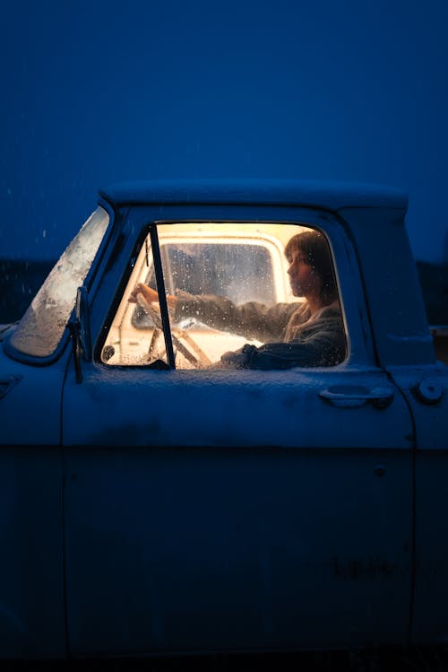 Woman Sitting in an Old Pick-up Truck in Winter