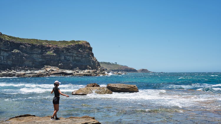 Woman Standing On Sea Shore