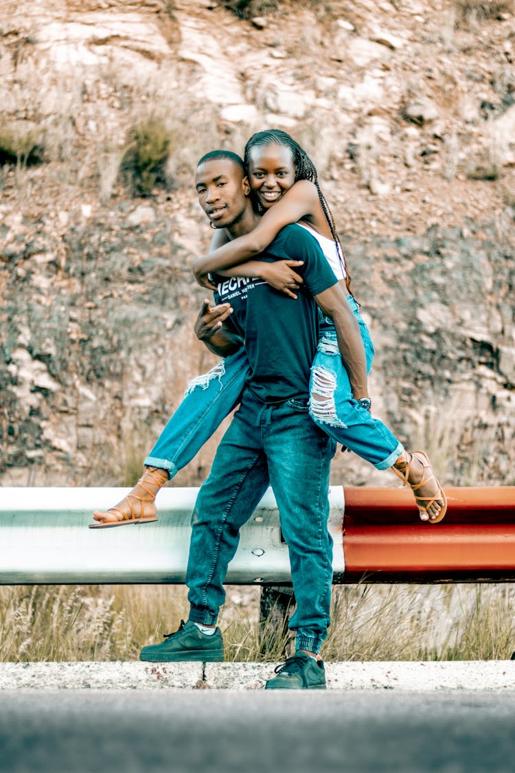 Man And Woman Piggybacking On Road