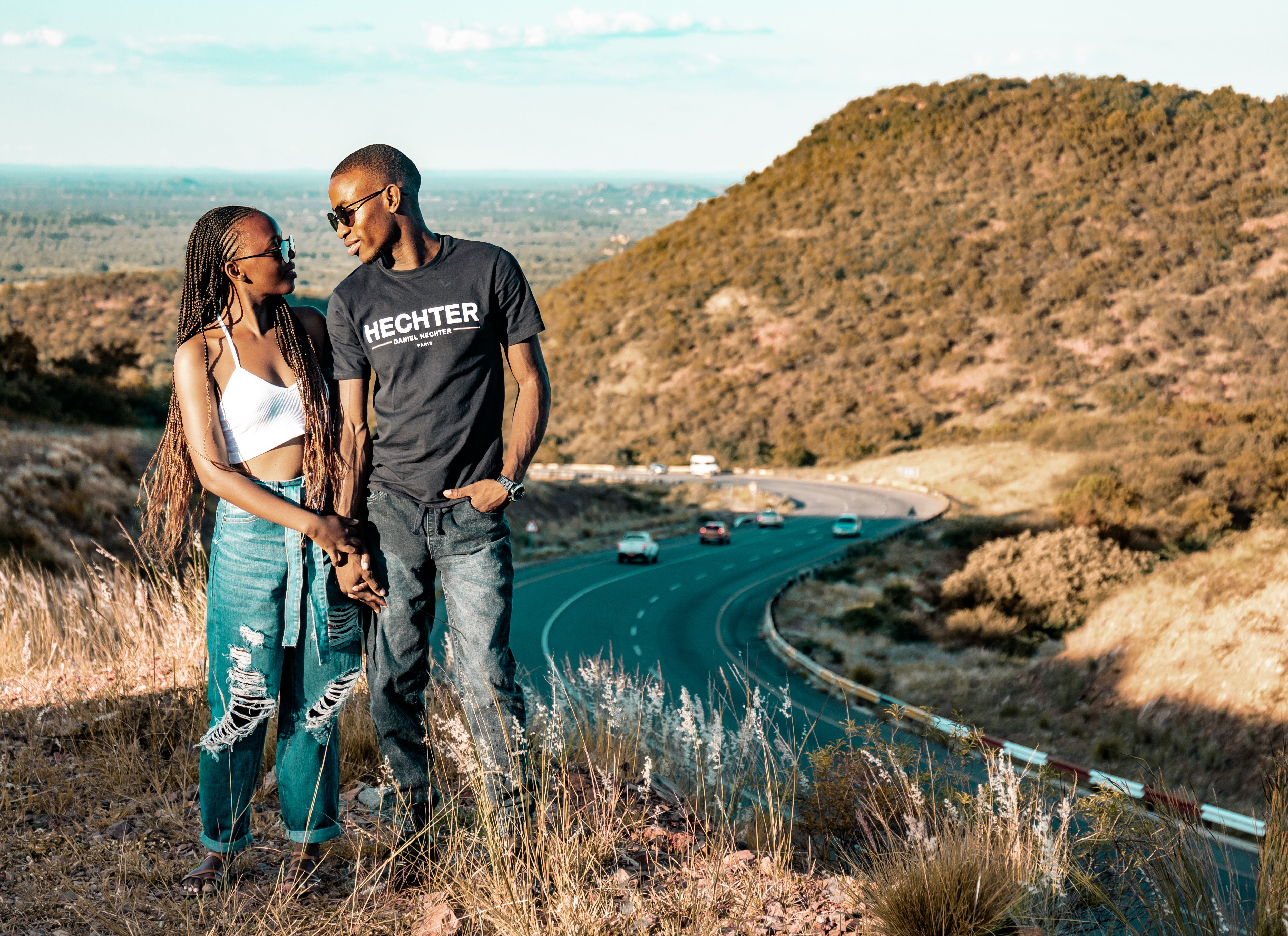 Couple Standing on a Hill Holding Hands · Free Stock Photo