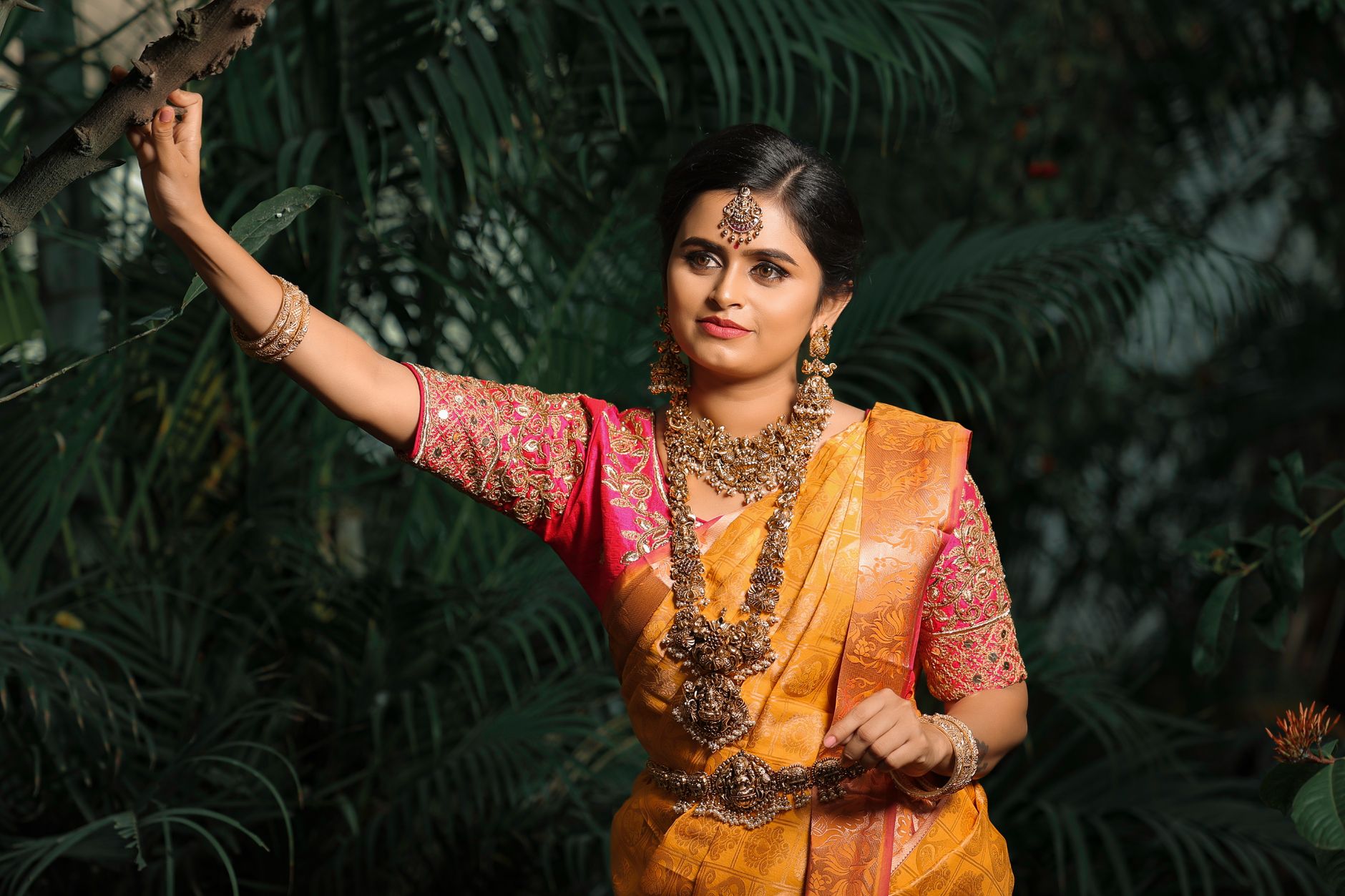Beautiful Indian bride in vibrant saree with intricate jewelry, embodying cultural elegance.