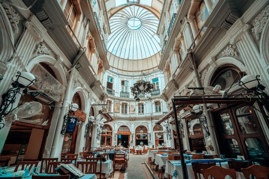 Stunning neoclassical architecture featuring an indoor restaurant under a glass dome in Istanbul.