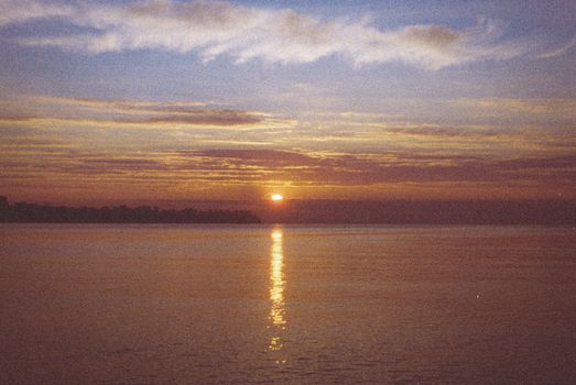 Breathtaking sunset over a tranquil lake with vibrant hues and reflective waters.