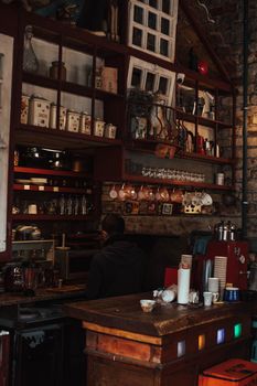 Warm and inviting café interior in Türkiye with a rustic vibe, showcasing a coffee machine and wooden counter.