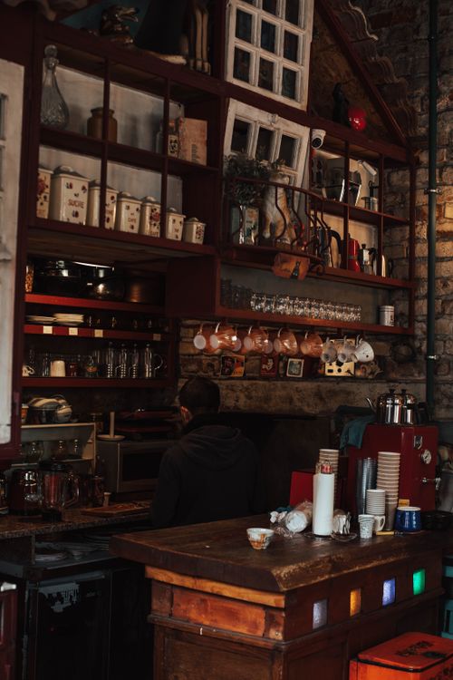 Free Warm and inviting café interior in Türkiye with a rustic vibe, showcasing a coffee machine and wooden counter. Stock Photo