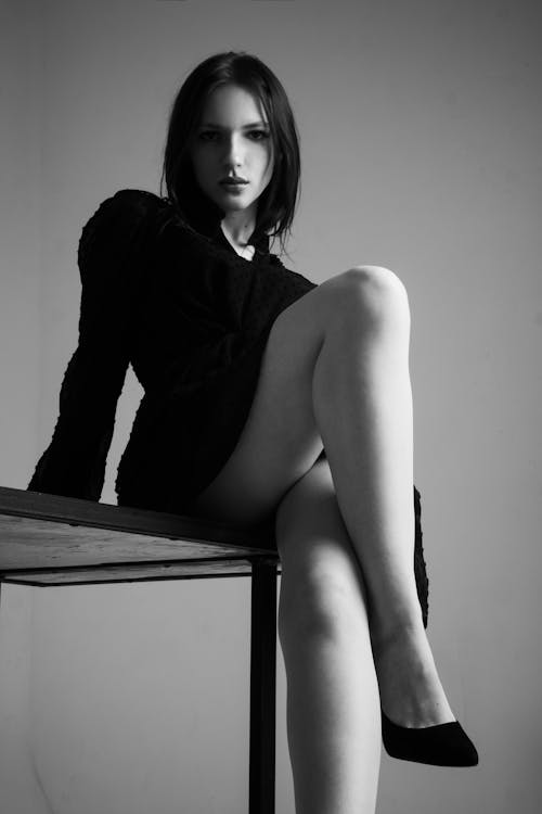 Woman Posing on Table in Black and White