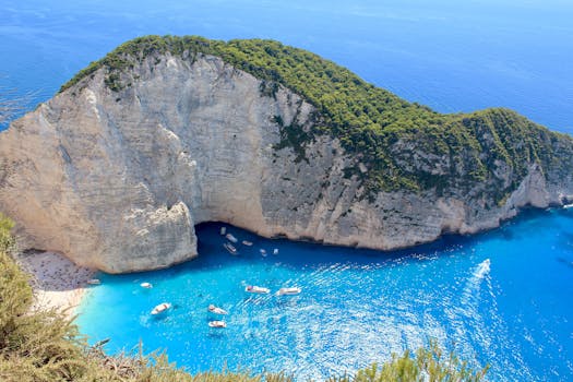 Stunning aerial view of Navagio Beach, Zakynthos, with turquoise waters and dramatic cliffs.