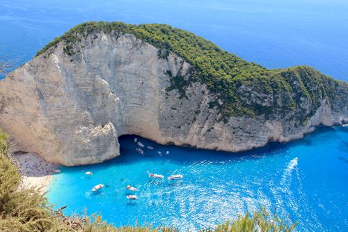 Free Stunning aerial view of Navagio Beach, Zakynthos, with turquoise waters and dramatic cliffs. Stock Photo