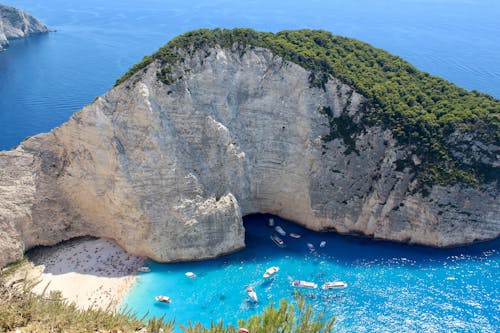 Motorboats in Bay with Beach and White Rocks