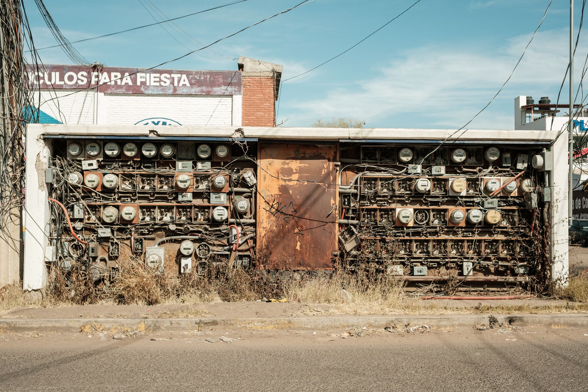 Abandoned rusty electrical panel with wires in Mexico street.