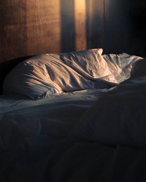 Free Sun Shining on a Bed with White Bed Sheets  Stock Photo