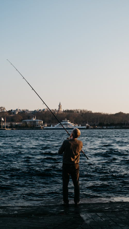 Gratis lagerfoto af fisker, fiskeri, fiskestang