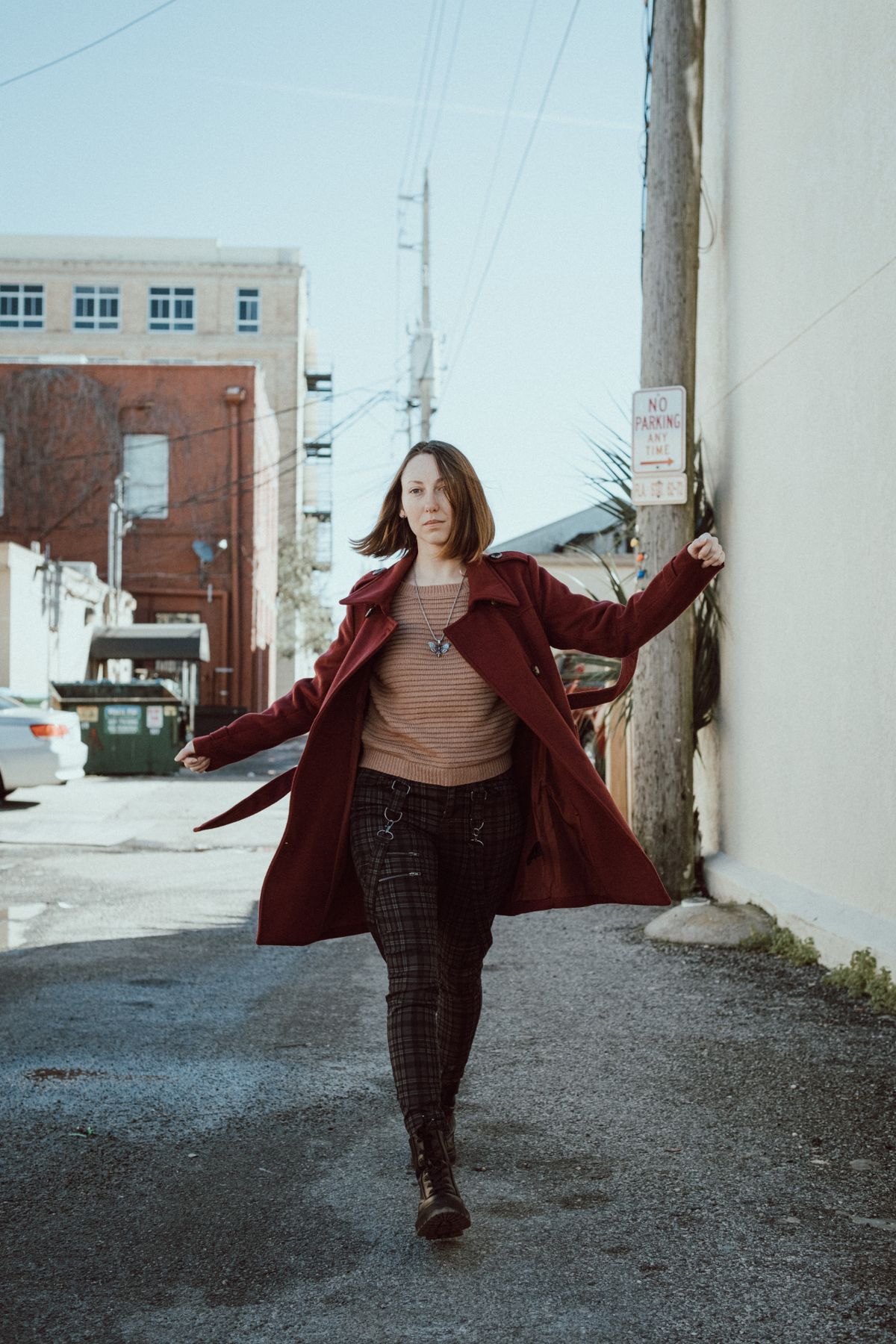 Burgundy Outfits for Women — 7 Wine Red Looks for Fall and Winter Woman in a burgundy wine red coat walking on a city street