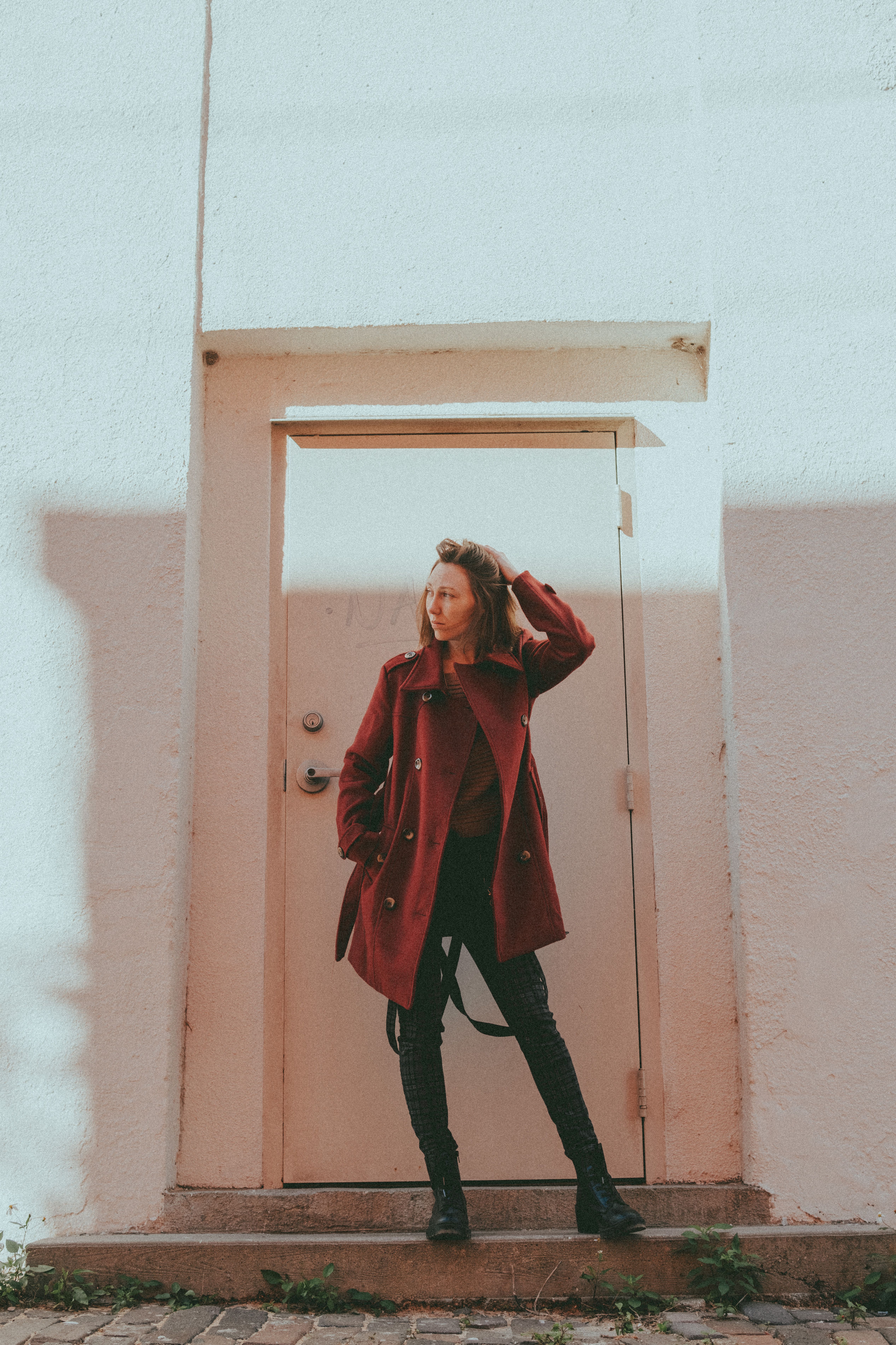 Woman Standing in Front of a Door · Free Stock Photo