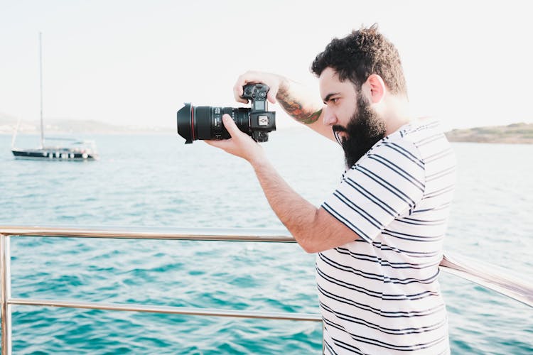 Man Taking Photos On A Yacht 