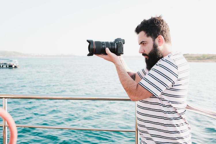 Man Taking Photos On A Boat 