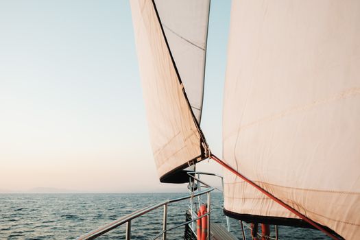 Experience the tranquility of sailing with white sails over the open sea.