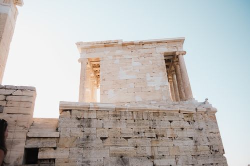 Free View of the ancient Temple of Athena Nike in Athens, Greece under a clear blue sky. Stock Photo