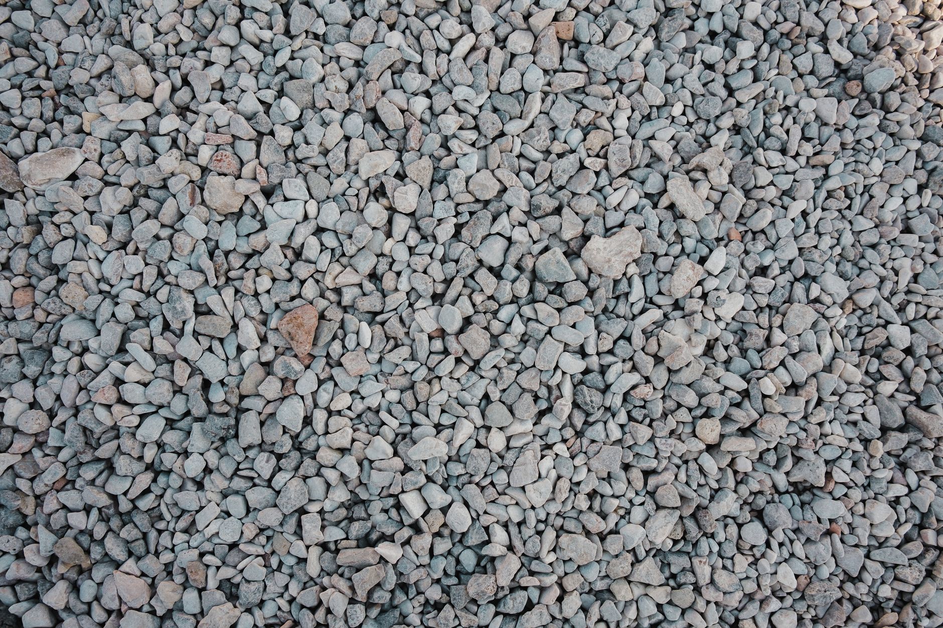 Detailed top view of a gravel stones background, ideal for construction use.