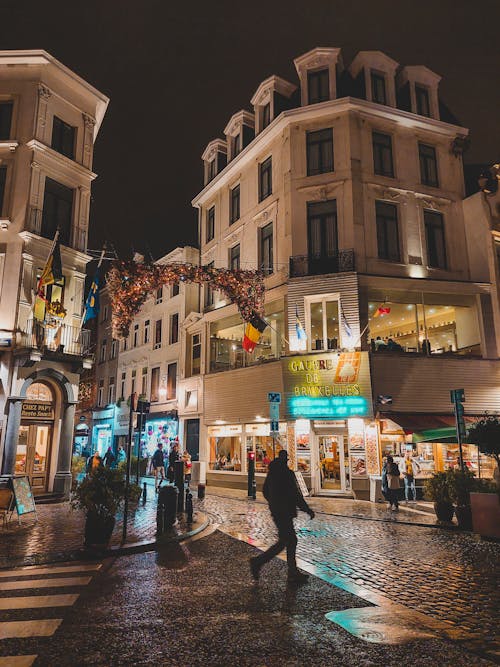 A person walking down a street at night