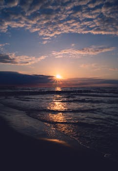 Stunning sunset over the Baltic Sea in Kołobrzeg, capturing the golden hues and serene waves.