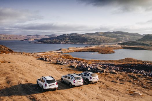 Off-road vehicles overlook the beautiful landscape in Teriberka, Russia.
