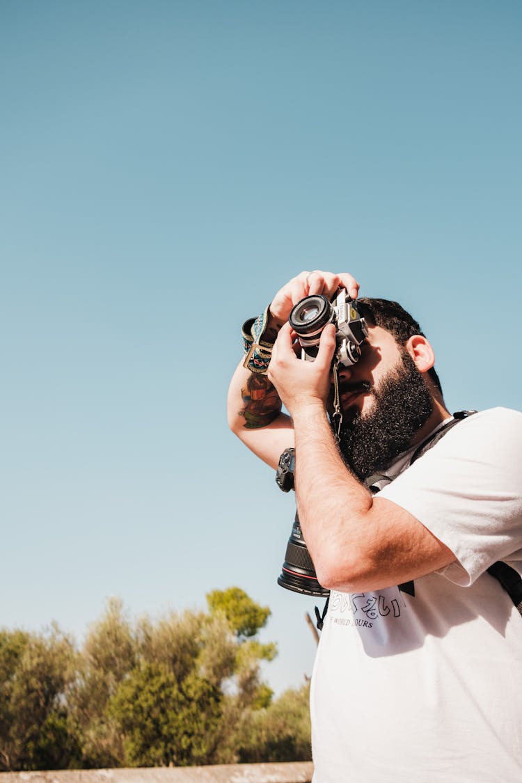 A Bearded Man Engaged In Photography