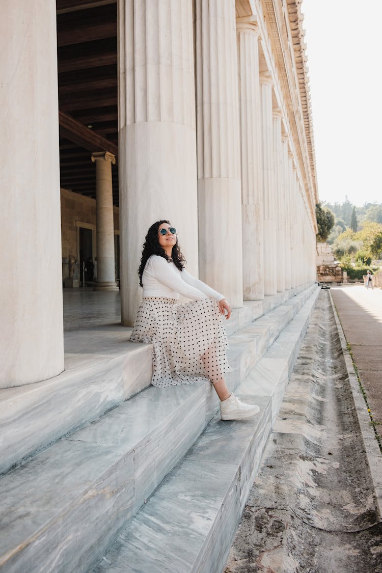 A Woman Sitting On Marble Steps