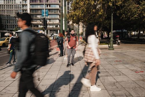 Free Urban scene featuring pedestrians on a busy city sidewalk during the day. Stock Photo