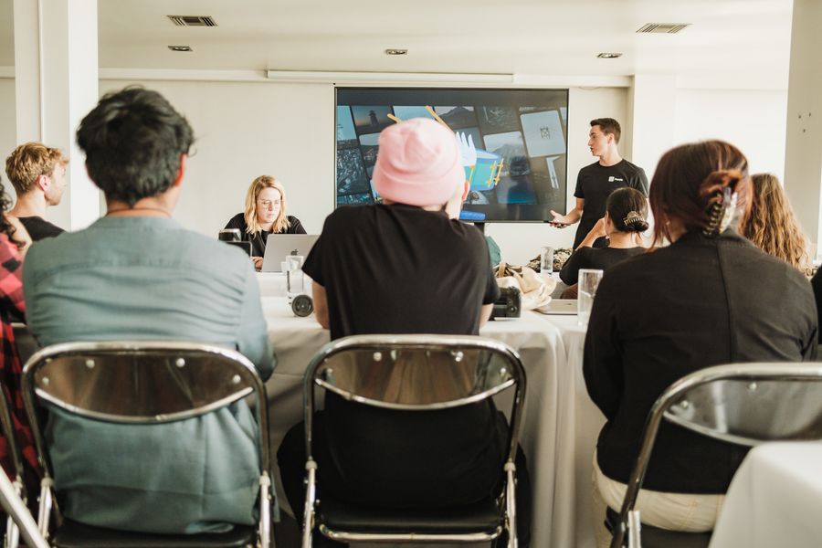 A diverse team in conversation around a table in a bright modern office.