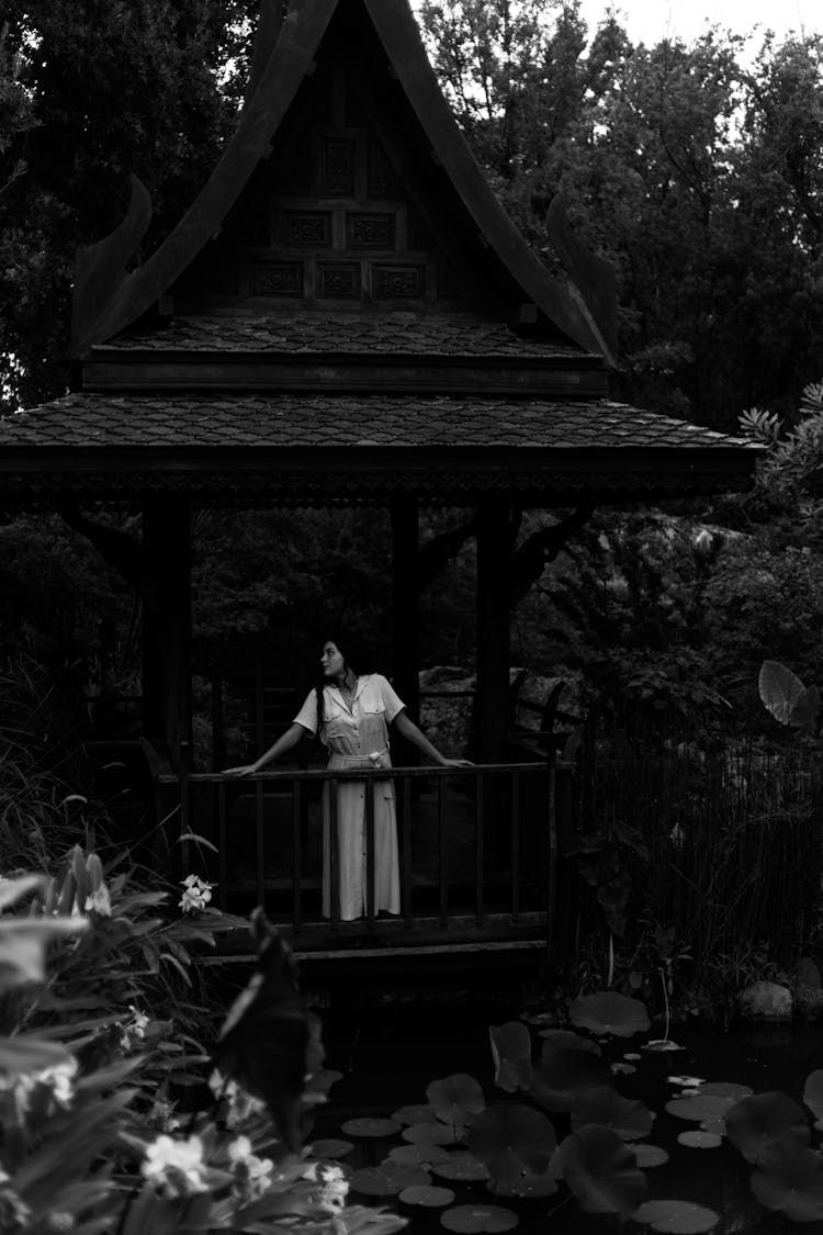 Woman Standing In A Pavilion In A Botanical Garden 