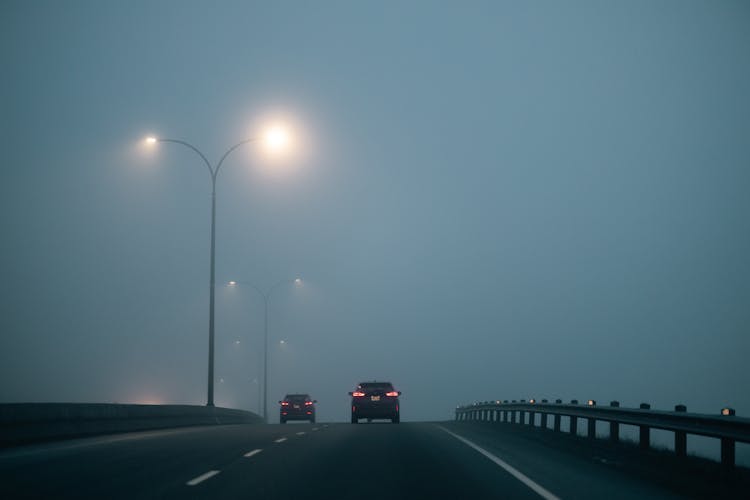 Cars On Highway Under Clouds