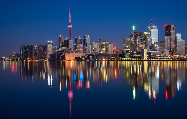 Buildings Near Body Of Water At Night 