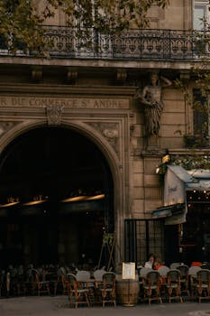 A peaceful Parisian street cafe under classic architecture in Saint-André, ideal for tourists.