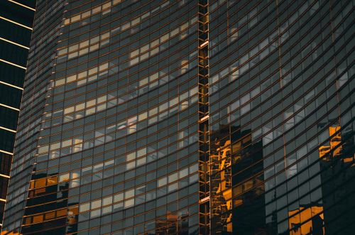 Free Stunning modern skyscraper facade reflecting the Miami cityscape at sunset. Stock Photo