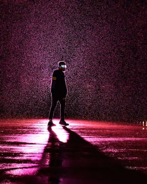 Rainfall over Man in Pink Light