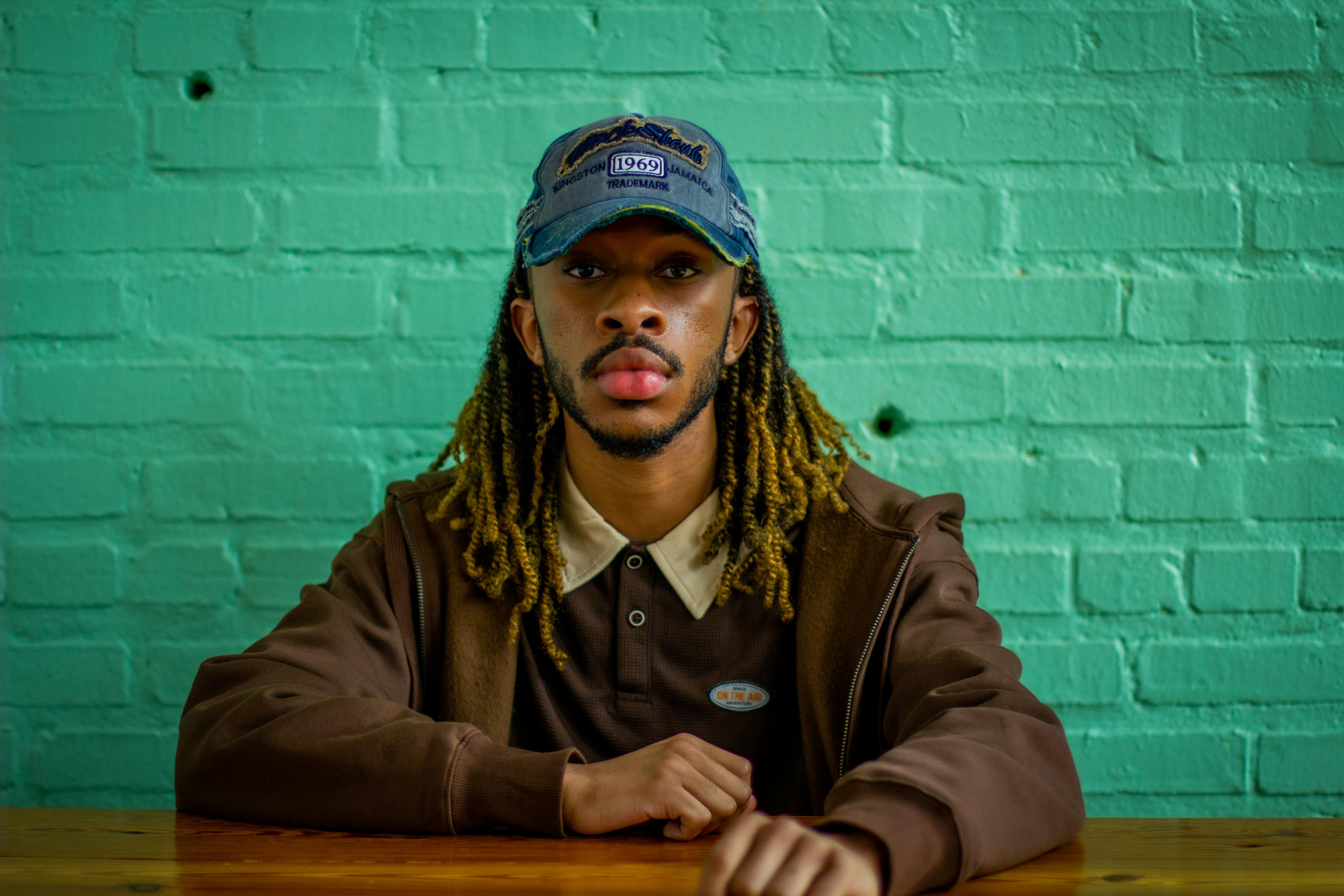 Man in Brown Jacket Wearing a Cap · Free Stock Photo