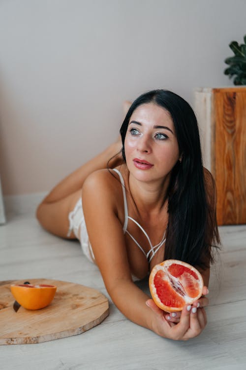 Brunette Woman Posing with Grapefruit