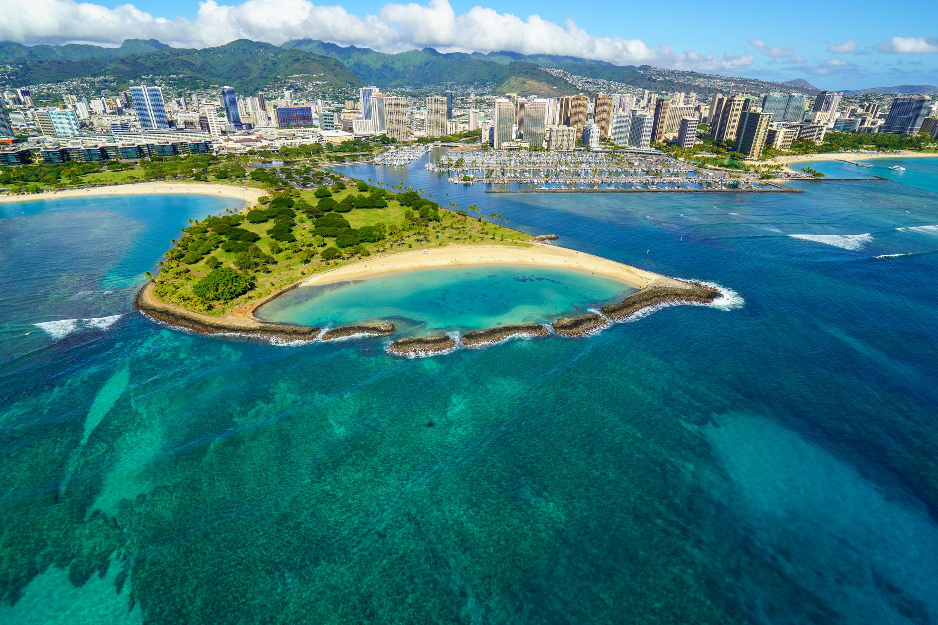 Photo by Cyrill Stunning aerial view of Honolulu's coastline with beaches, skyscrapers, and turquoise waters.