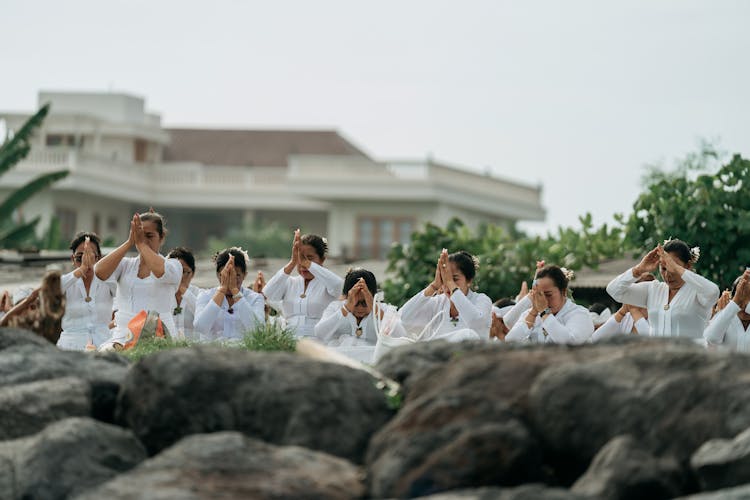 Group Of Women Praying Outdoors