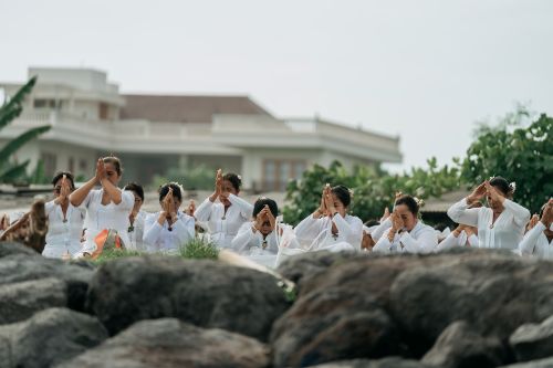 Free A group of women engaged in a spiritual prayer session outdoors in Sanur, symbolizing unity and devotion. Stock Photo