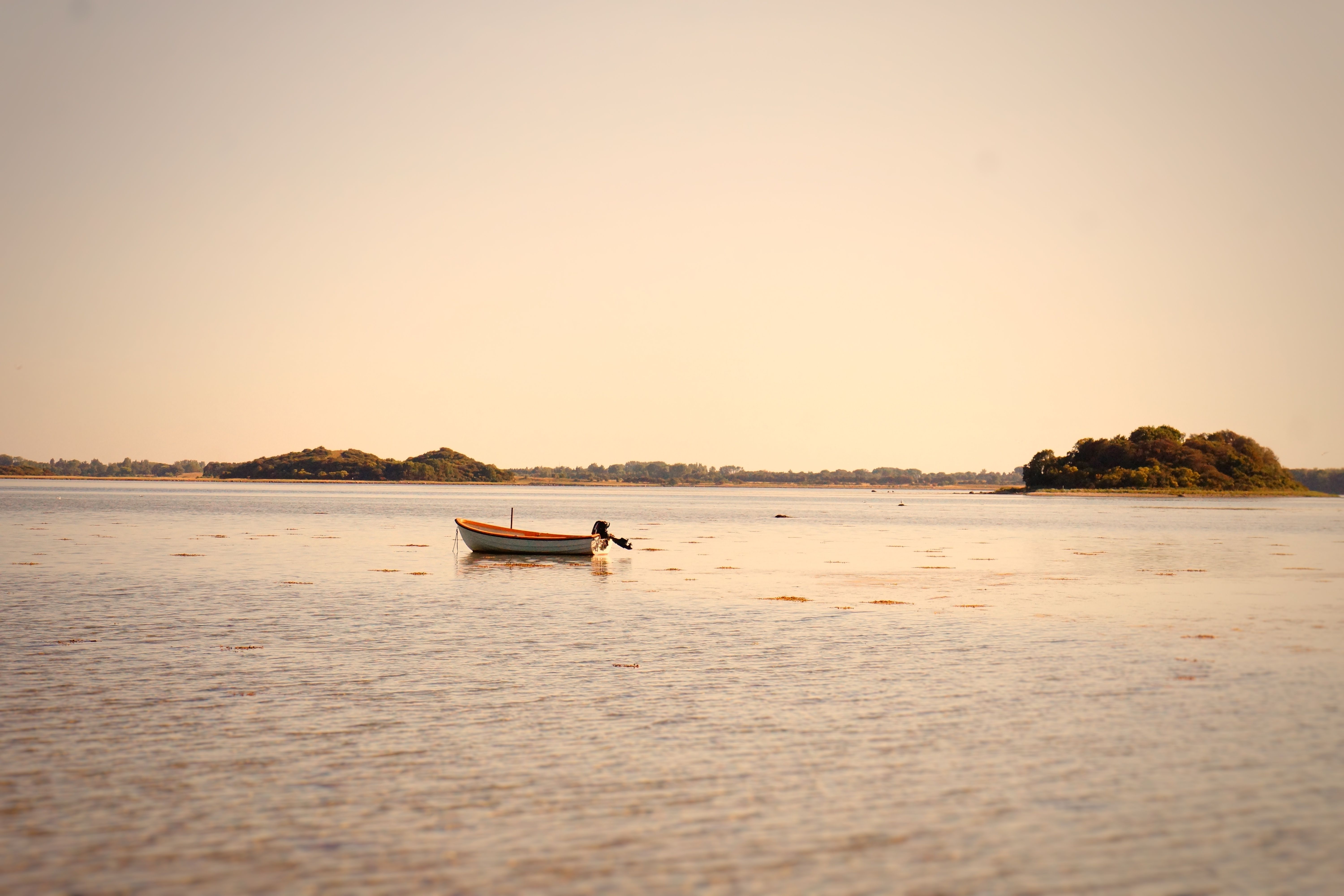 White Boat on Body of Water During Sunset · Free Stock Photo