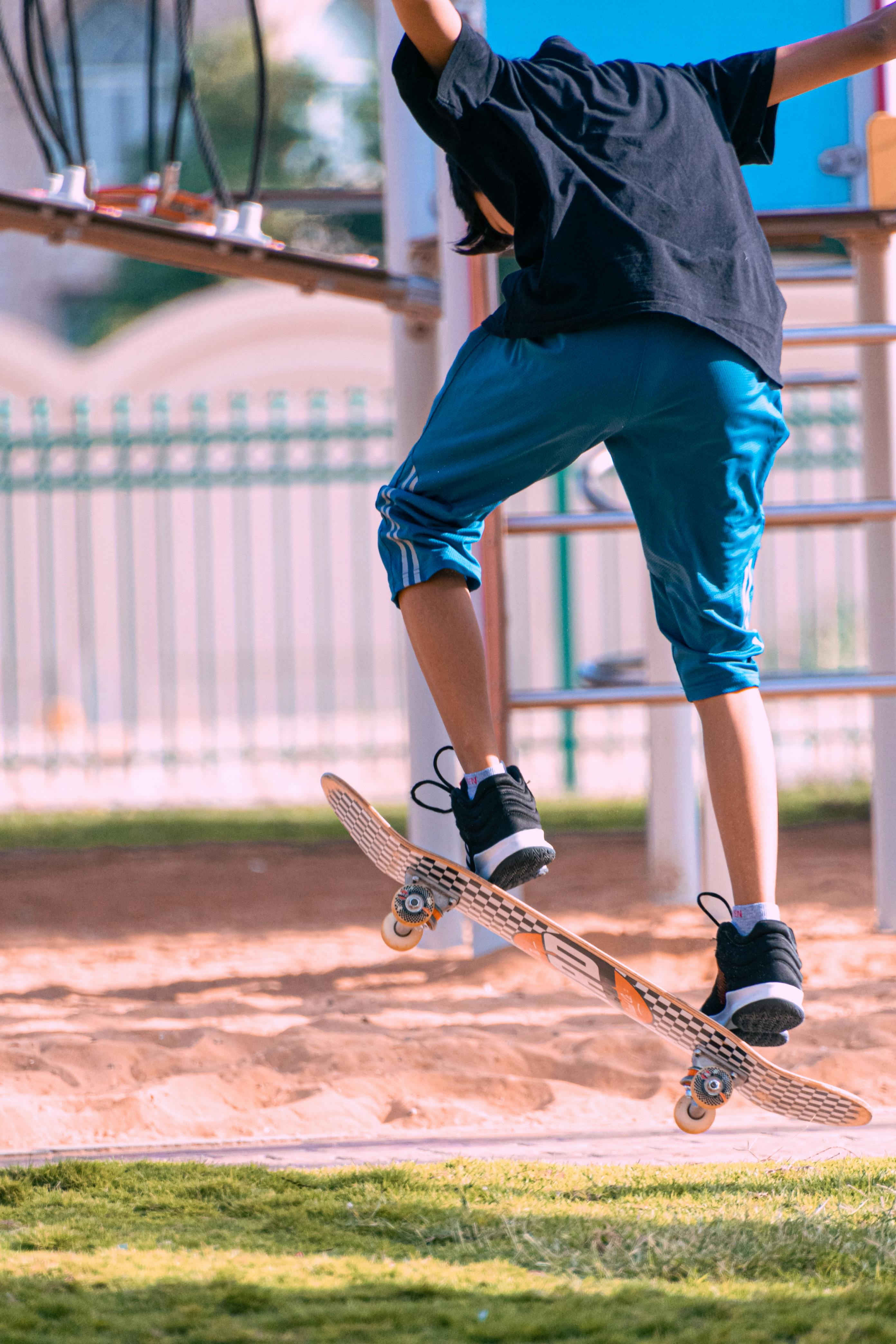 teenager boy jumping on a skateboard